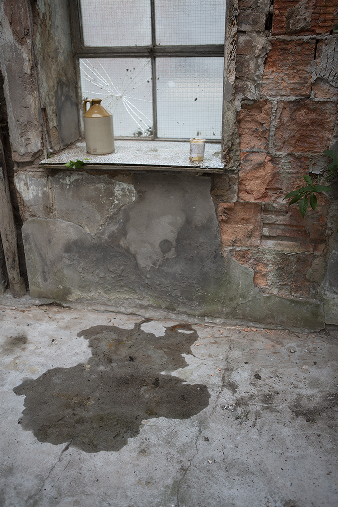 Dark wet puddle on cement floor